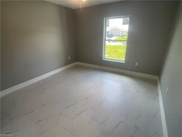 Unfurnished room with baseboards