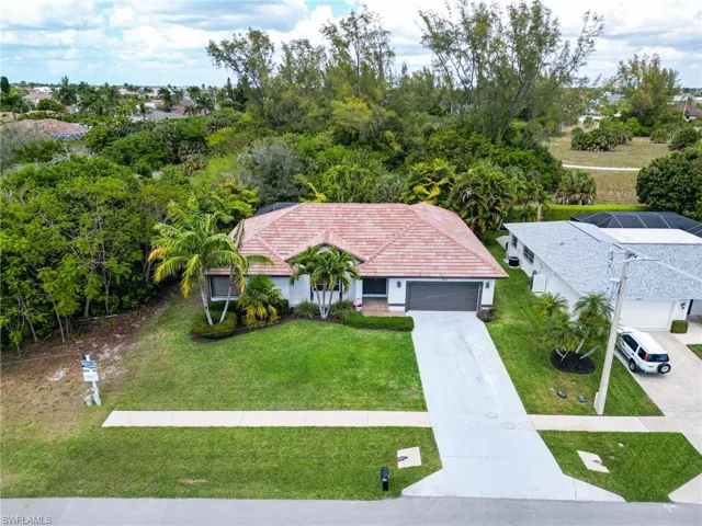 View from above of property with a tree filled landscape