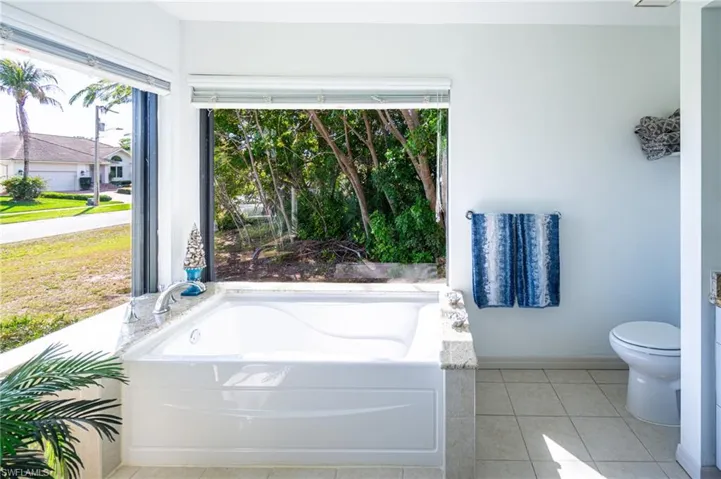 Full bath with a bath and light tile patterned floors