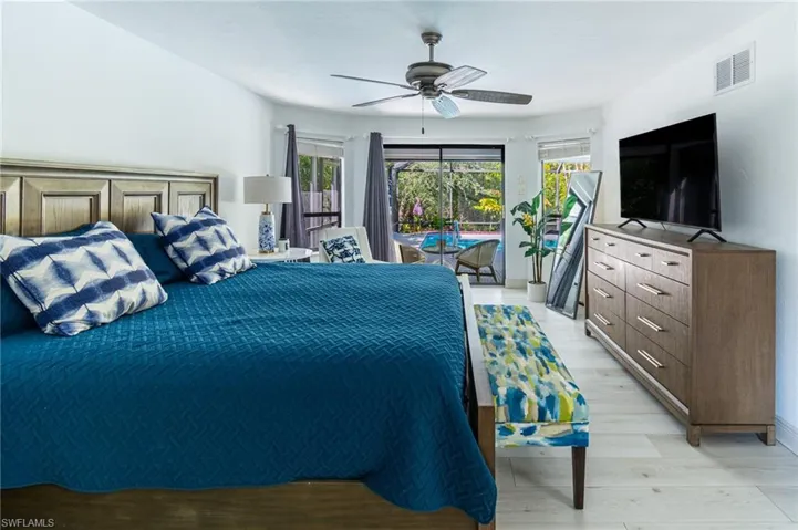 Bedroom featuring access to exterior, light wood finished floors, and ceiling fan