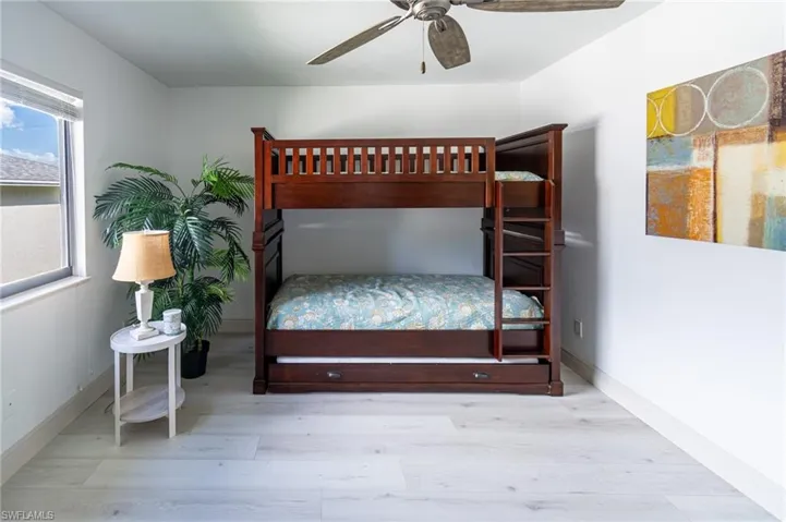 Bedroom with light wood-style flooring and a ceiling fan