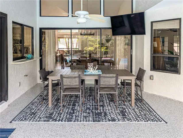 View of patio with ceiling fan and outdoor dining area