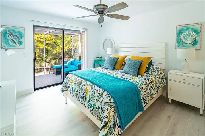Bedroom featuring light wood finished floors, access to outside, and ceiling fan