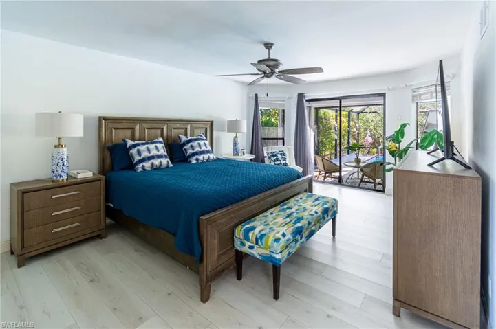 Bedroom featuring access to outside, light wood-type flooring, and a ceiling fan