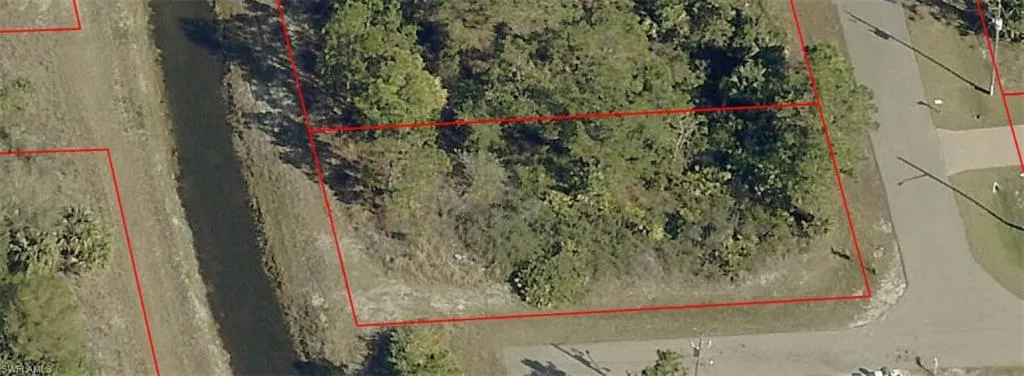 Aerial map of property and surrounding area featuring property parcel outlined