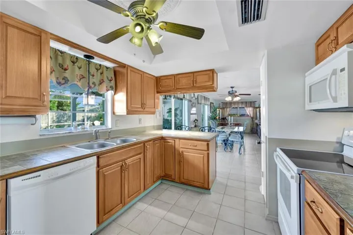 The Kitchen overlooks the pool area + open plan dining area