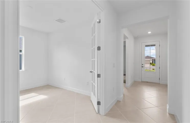 Hall with light tile patterned flooring