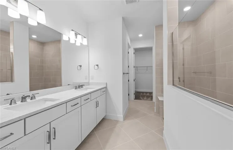 Bathroom with double vanity and tile patterned floors