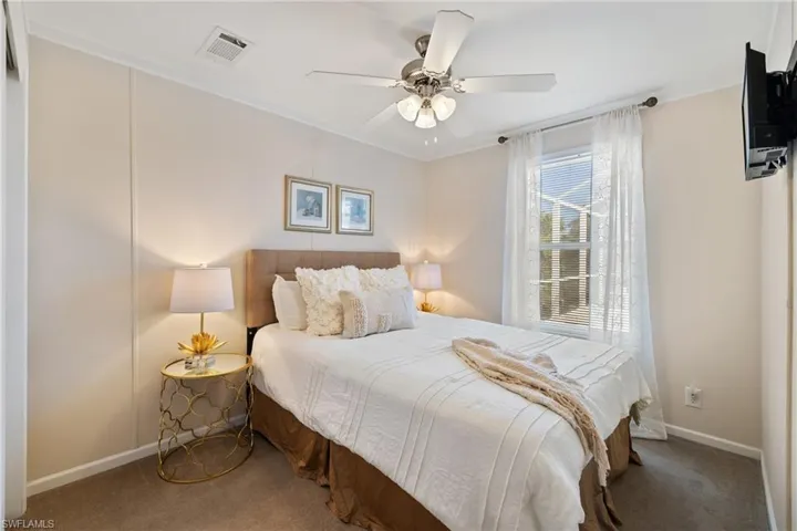 Bedroom with baseboards, carpet flooring, visible vents, and a ceiling fan