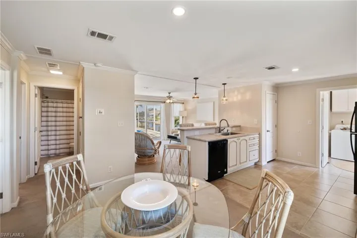 Dining room with recessed lighting, visible vents, and crown molding
