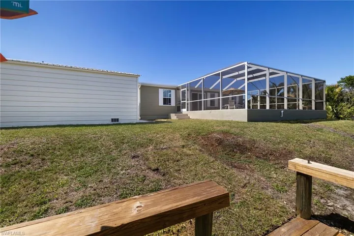 View of yard with glass enclosure