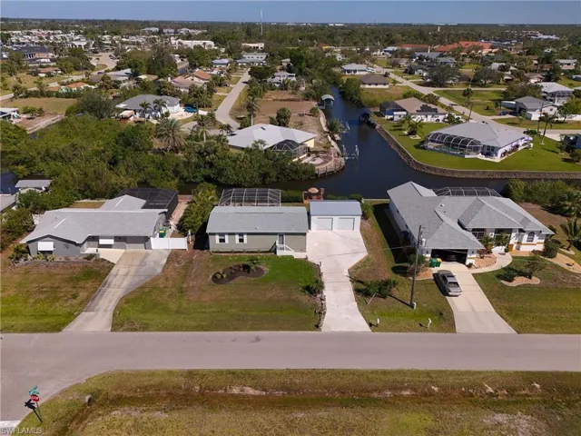 Drone / aerial view with a water view and a residential view