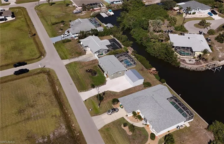 Drone / aerial view featuring a water view and a residential view