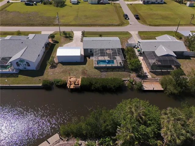 Birds eye view of property with a residential view and a water view