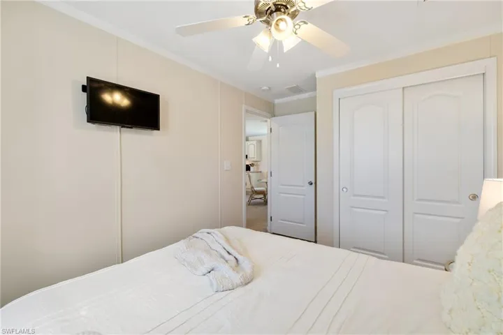 Bedroom with visible vents, ornamental molding, a closet, and a ceiling fan