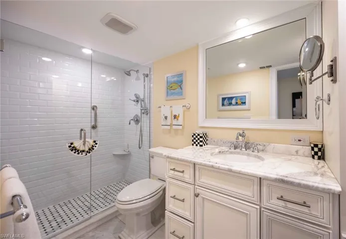 Bathroom with vanity, a stall shower, and light tile patterned floors