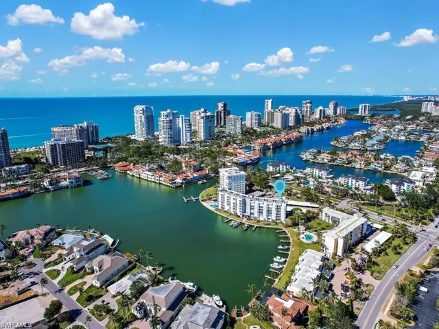 View of urban area featuring a nearby body of water and a marina
