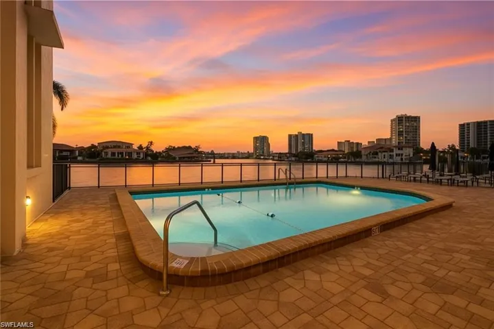 Community pool with a patio area and a city view