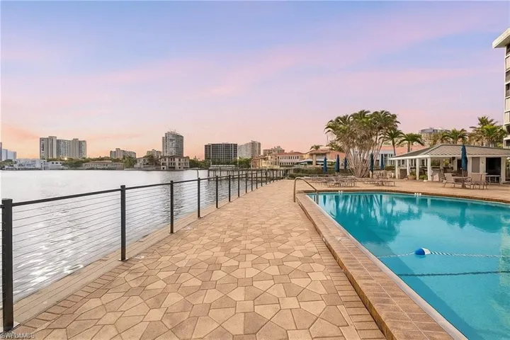 Community pool featuring a patio area and a view of city