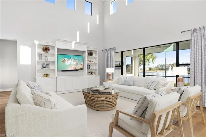 virtual staged Living room featuring light wood finished floors and a high ceiling