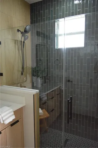 Bathroom featuring vanity and an enclosed shower