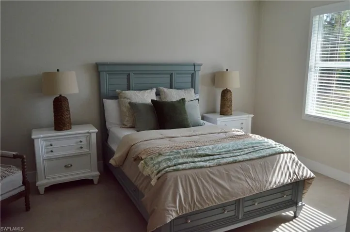 Carpeted bedroom with multiple windows