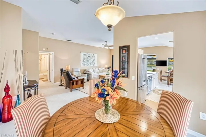 Dining room featuring vaulted ceiling and light tile patterned floors