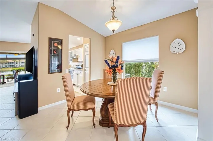 Dining area featuring lofted ceiling and light tile patterned floors