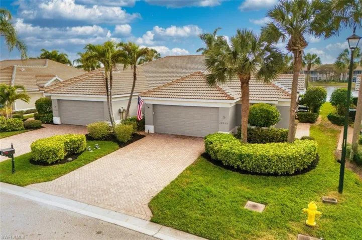 View of front of house with a garage, stucco siding, decorative driveway, and a tiled roof