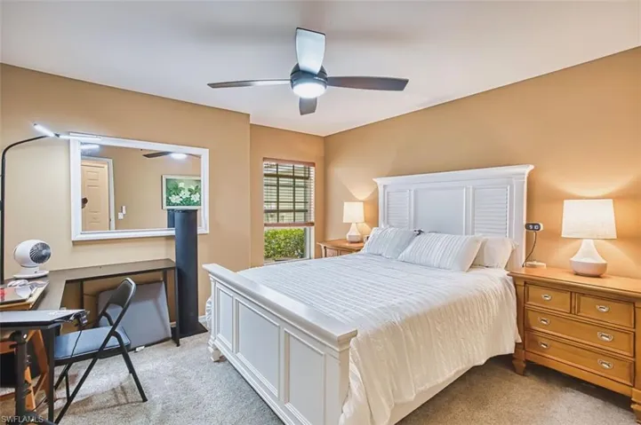 Bedroom featuring light carpet and a ceiling fan