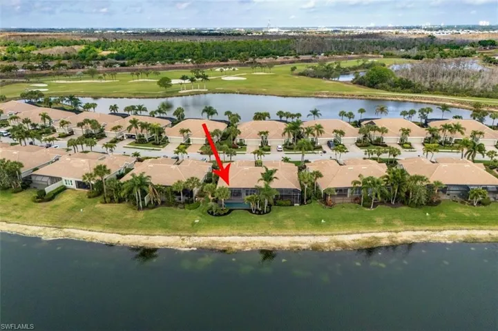 Aerial view of residential area with a nearby body of water and a golf course