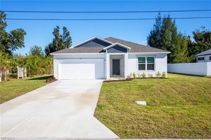 Ranch-style house with an attached garage, concrete driveway, roof with shingles, and stucco siding