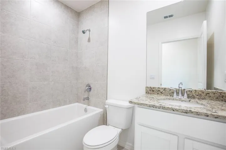 Full bath featuring vanity and shower / bathtub combination