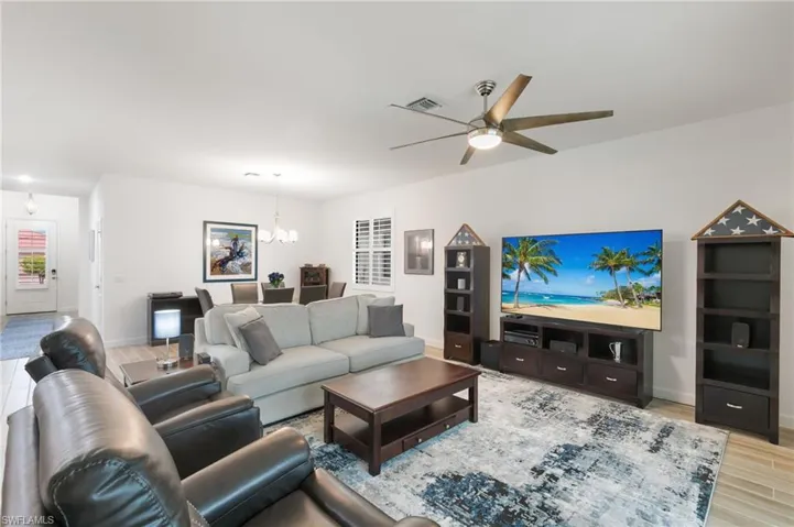 Living area featuring light wood finished floors and a chandelier