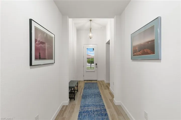 Hall featuring wood finish floors and baseboards