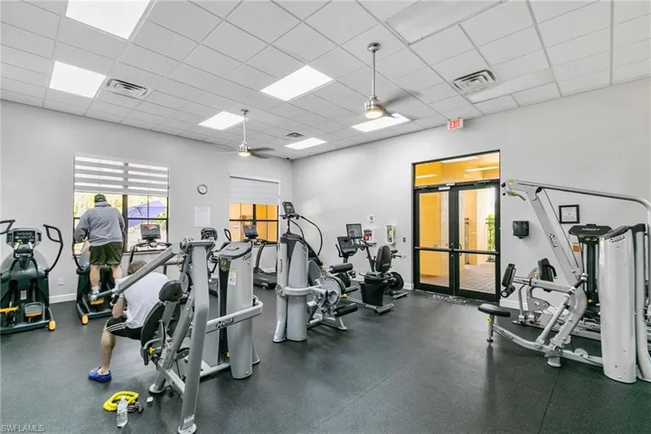 Workout area featuring a paneled ceiling and ceiling fan