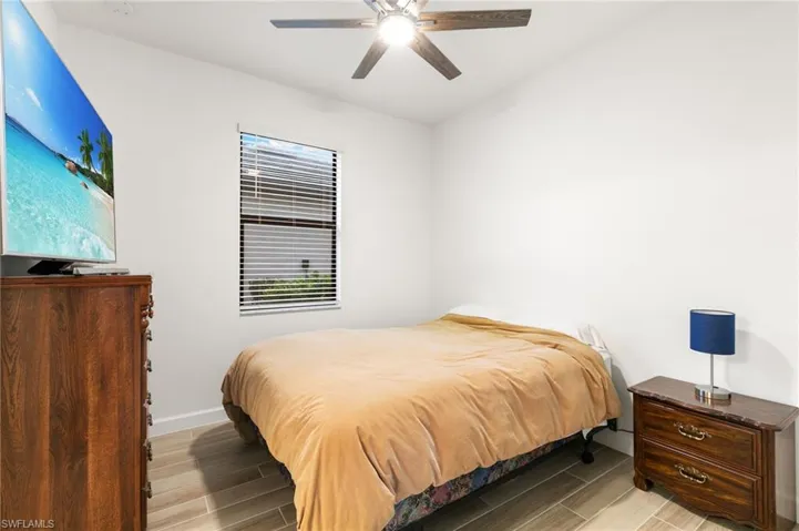 Bedroom with wood finish floors and ceiling fan