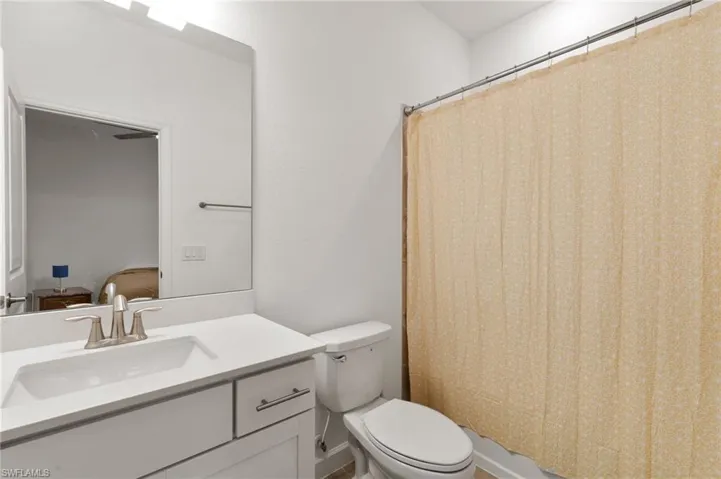 Bathroom with vanity and a shower with shower curtain