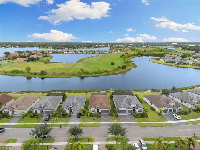 Aerial view of residential area featuring a nearby body of water
