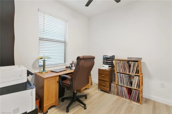 Home office featuring wood finish floors and a ceiling fan