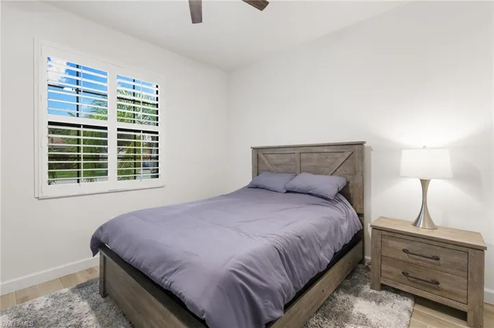 Bedroom featuring light wood-type flooring and a ceiling fan