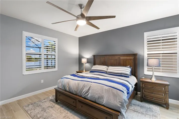 Bedroom with wood tiled floors and ceiling fan