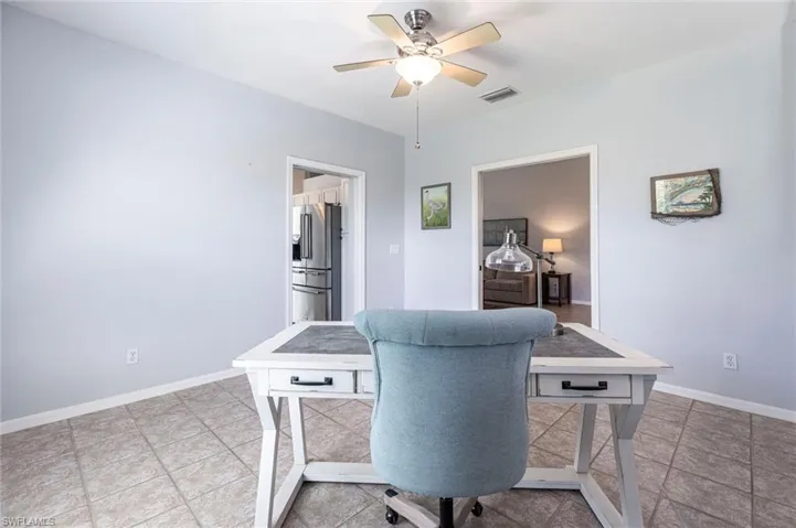 Office area featuring baseboards and ceiling fan