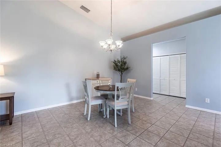 Dining area with a chandelier and light tile patterned floors
