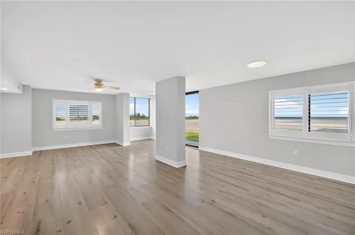 Unfurnished living room with light plank tile floors, recessed lighting, and a ceiling fan