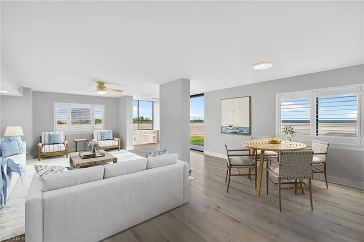 Living area featuring plank tile floors, ceiling fan, and recessed lighting