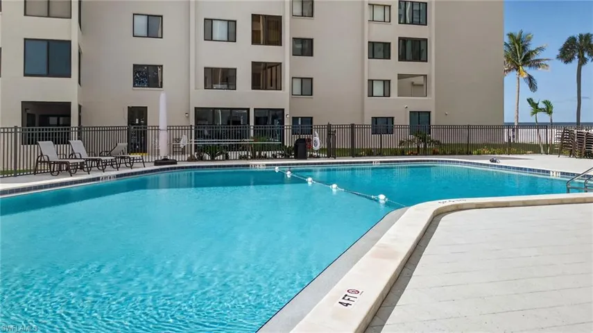 Community pool with a patio