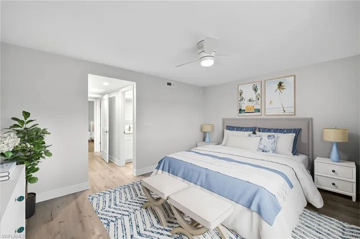 Bedroom featuring plank tile finished floors and ceiling fan
