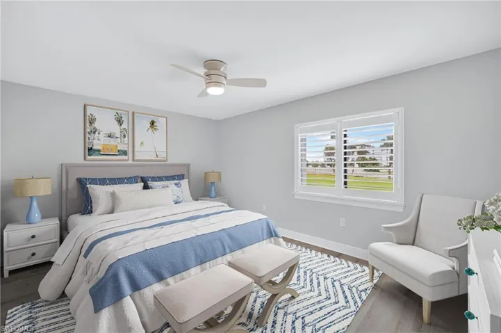 Bedroom featuring plank tile floors and a ceiling fan