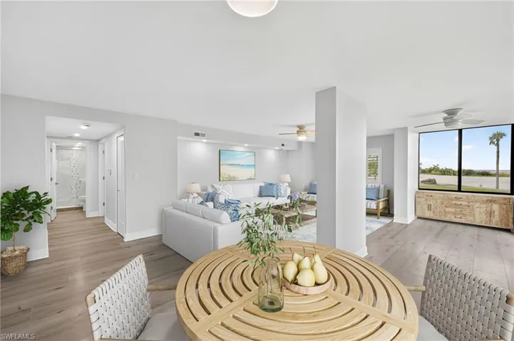 Living room with plank tile flooring and ceiling fan